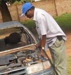 looking over his car after an accident